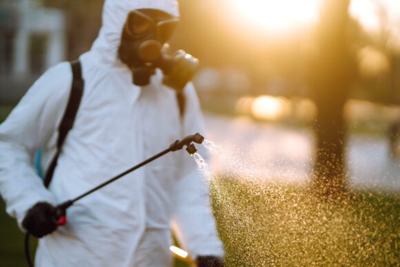 man spraying chemicals.